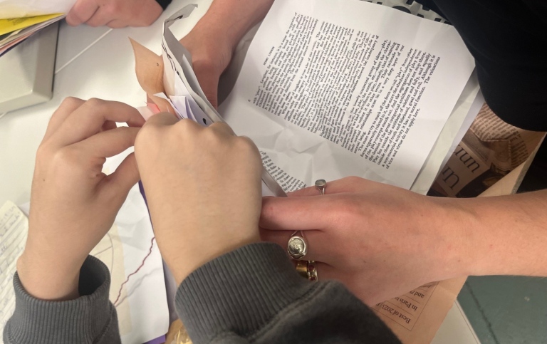 Hands working with book pages.