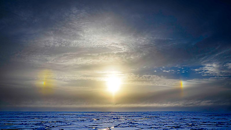 The sun, two sundogs,clouds and ice.