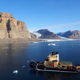 Icebreaker Oden outside northwestern Greenland, two glaciers on the background.