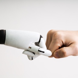 Genrebild: en robothand och en mänsklig hand möts i en fistbump. Foto: Andrey Popov/Mostphotos.