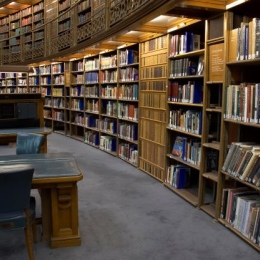 Library shelves showing old books with leather binding.