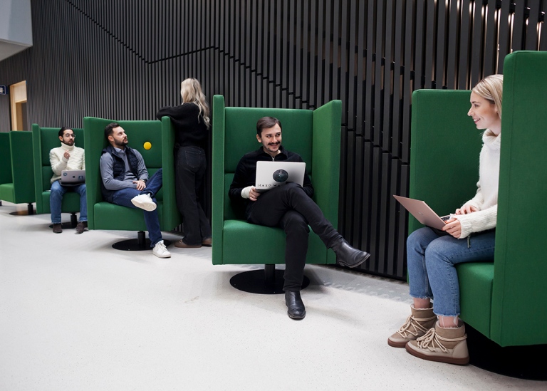 Students sitting in green couches at Campus Albano, Stockholm University