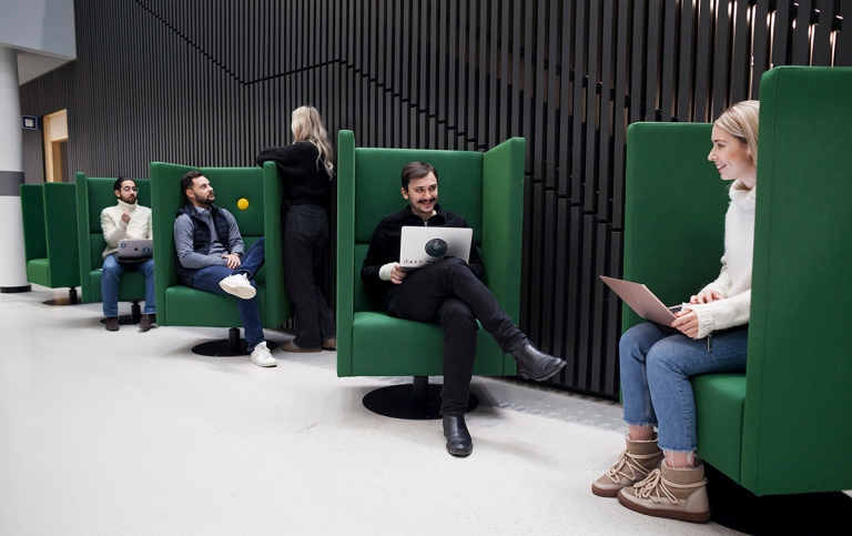 Students sitting in green couches at Campus Albano, Stockholm University