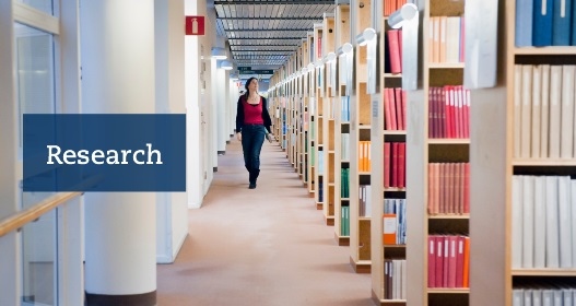 Person walking through a library.