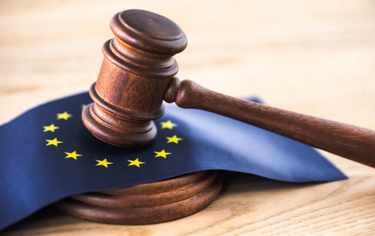 gavel of judge with european union flag on wooden table