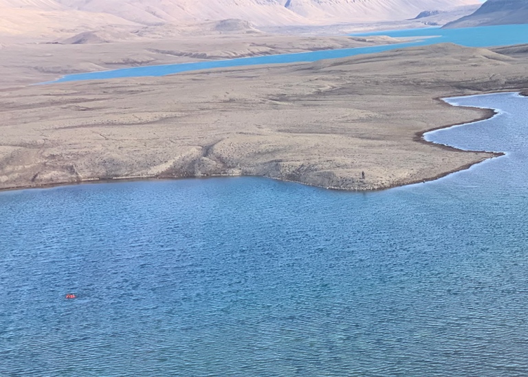 View of lake from helicopter, person in the lake