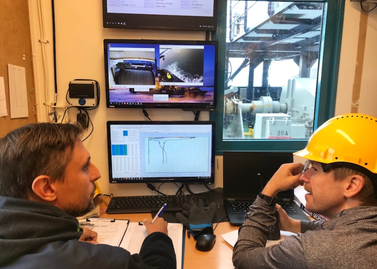 two scientists looking at data on computer screens, onboard icebreaker Oden