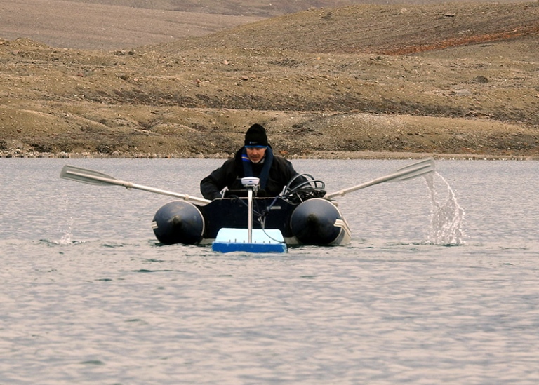 scientist on rubber boat rowing