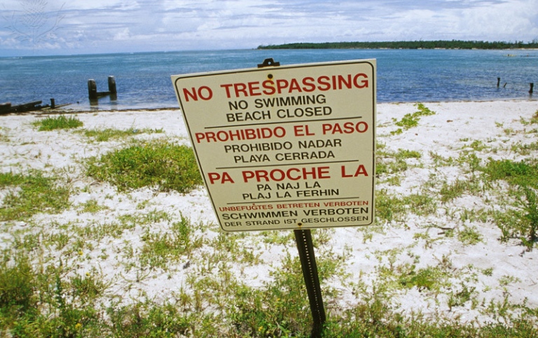 Florida, Virginia Key, Biscayne Bay. No Trespassing Sign in 4 languages
