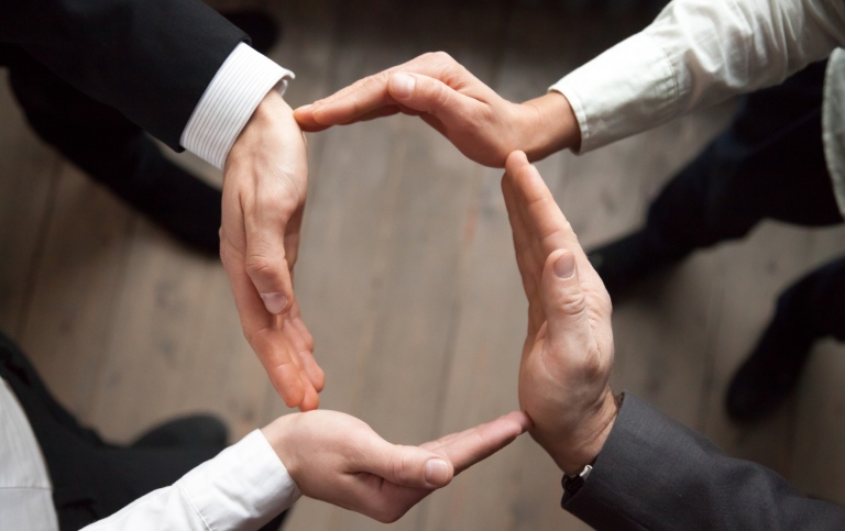 Business team people join hands forming circle