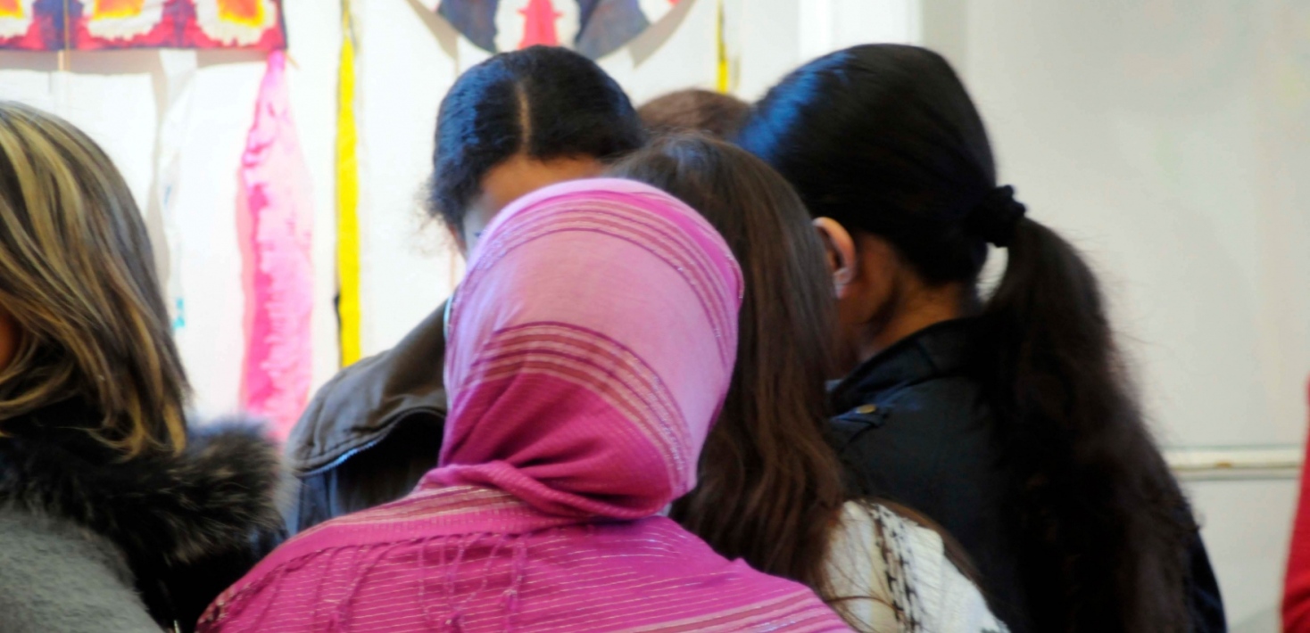 Mixed group of students in class room. 