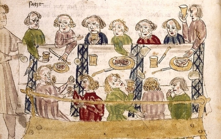 medeltida teckning. flera personer äter mat runt ett bord. 