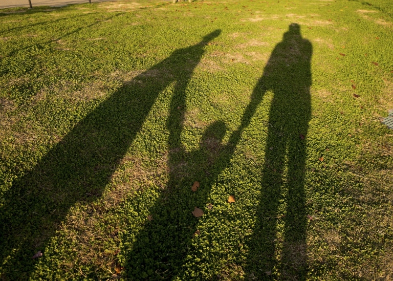 Shadow of a child with parents