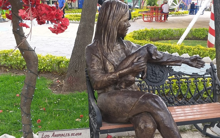 Staty av en kvinna som sitter i en parkbänk med en hund - Parque del Obrero, Ciudad de México