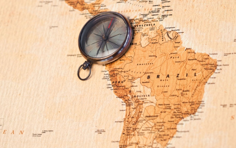 World map with compass showing south america. Photo by Mostphotos