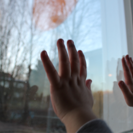 Hands against window.