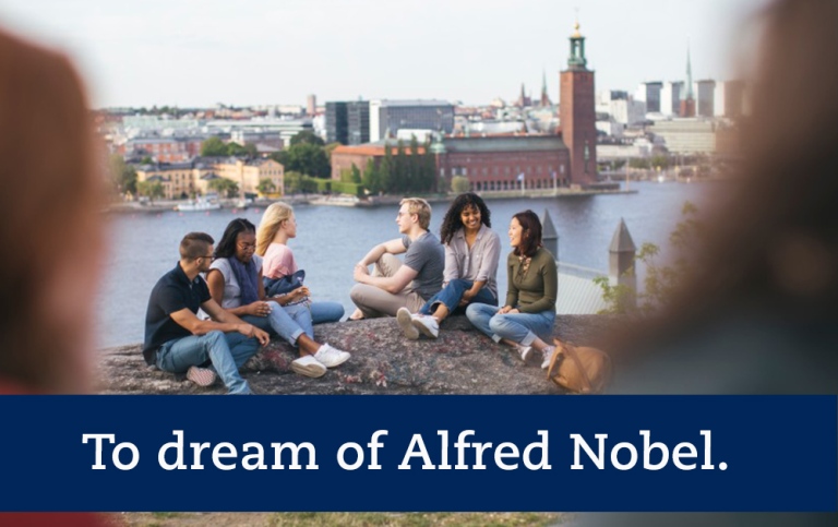 To dream of Alfred Nobel. Group of students sitting down on hill with City Hall in the background