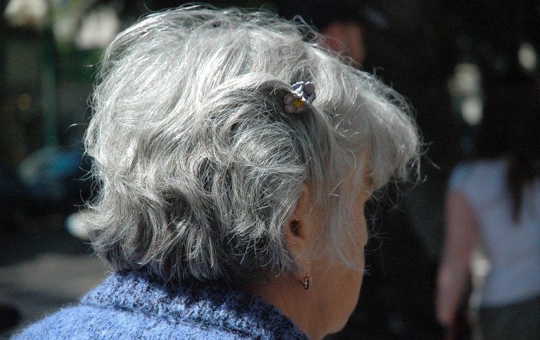 An elderly woman seen from behind