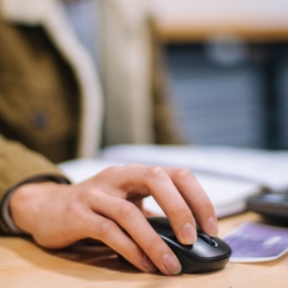 Genre photo of a hand using a computer mouse.