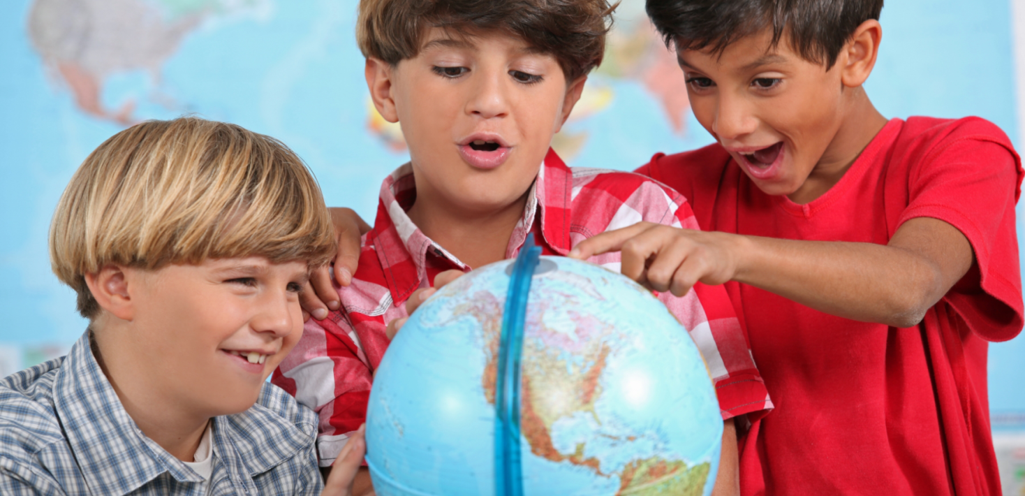 Children looking at a globe.