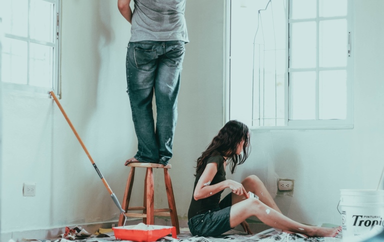 A couple painting their apartment