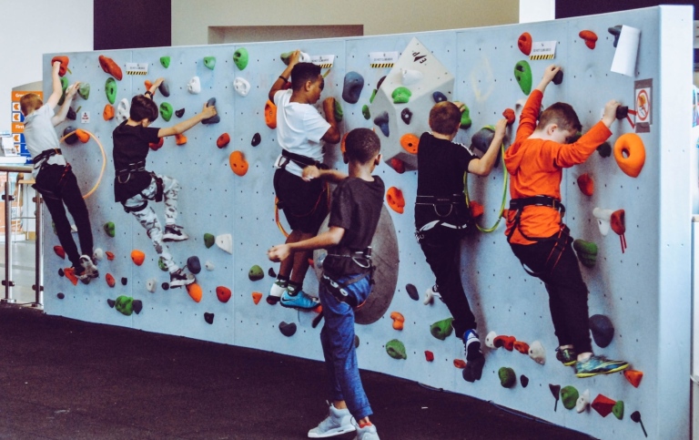 A group of children climbing indoors