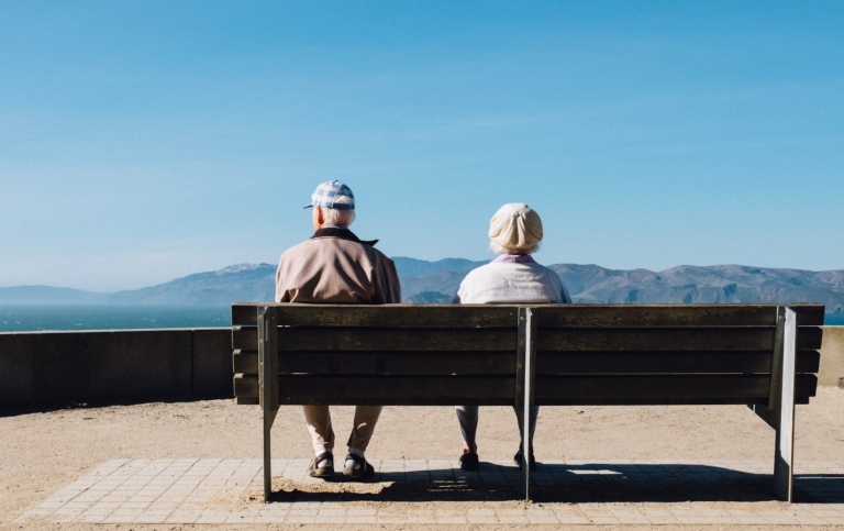 Old man and woman sitting on a bench