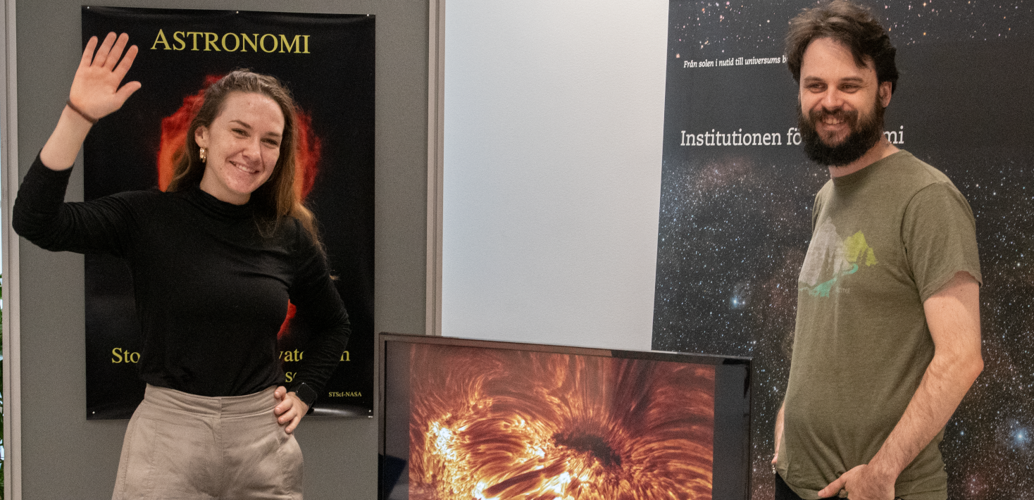 Moa Skan (left) and Axel Runnholm (right) in front of some astronomy posters