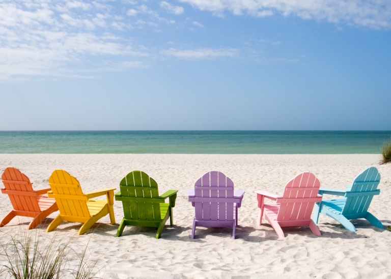 Colourful sun chairs on a beach.
