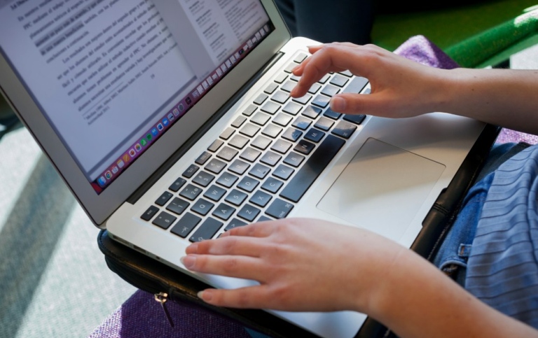 Hands writing on a keyboard