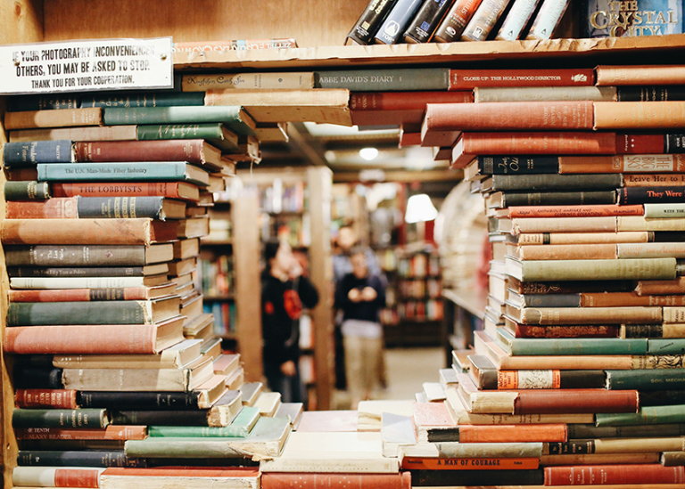 Piles of books form a round window