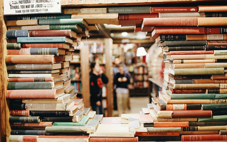 Piles of books form a round window