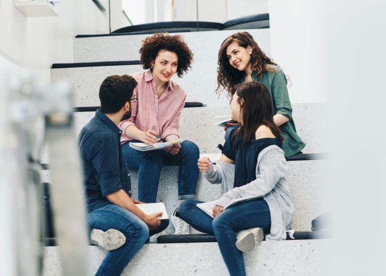 A small group of students talking to each other.